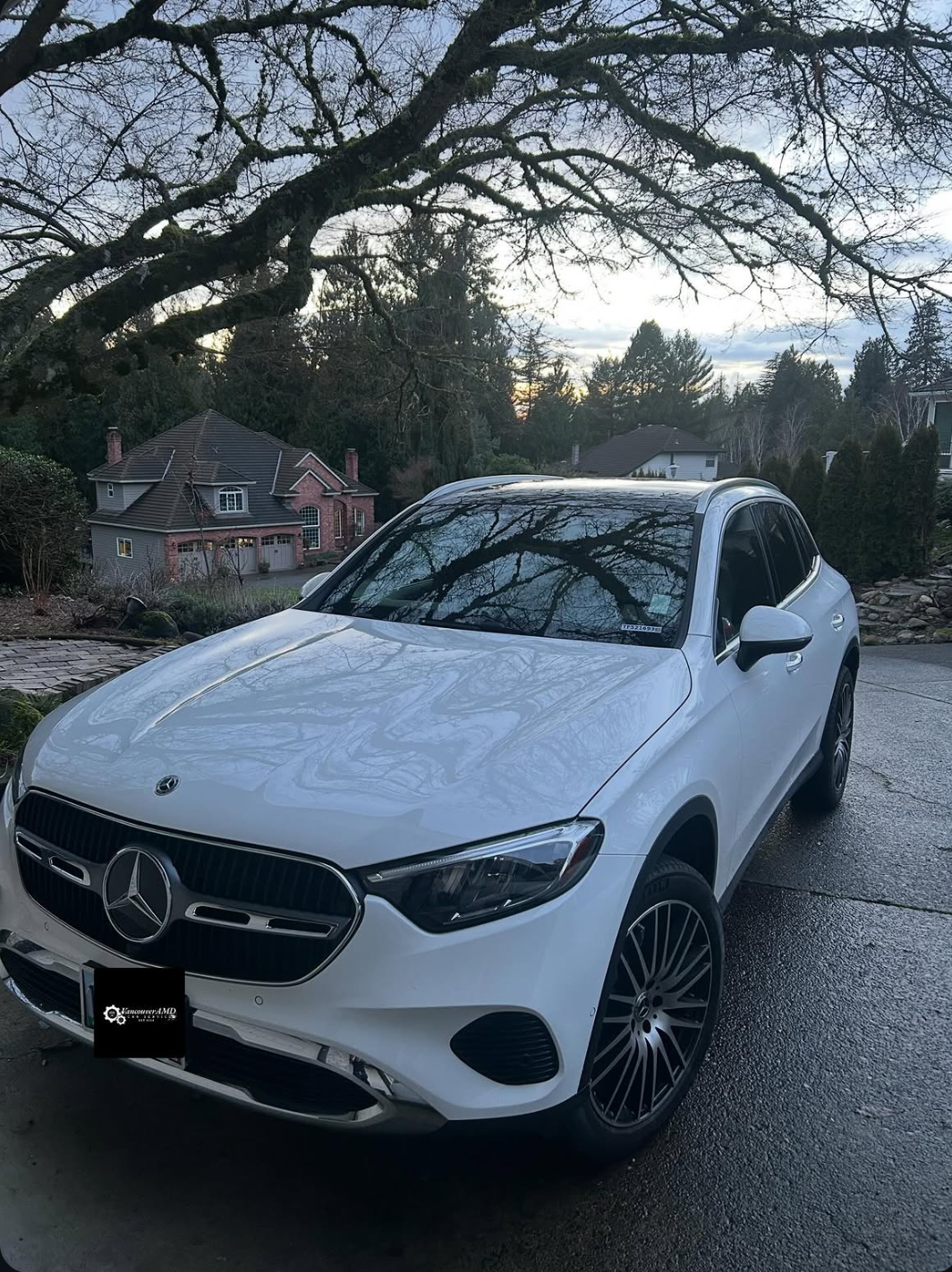 White Mercedes GLC with glossy paint in a driveway at dusk